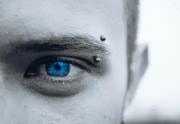 selective photo of man's blue eye