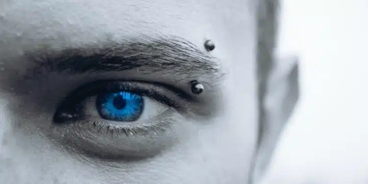 selective photo of man's blue eye